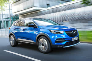 Stylish Opel Grandland X Cruising Through A Stunning Landscape Wallpaper