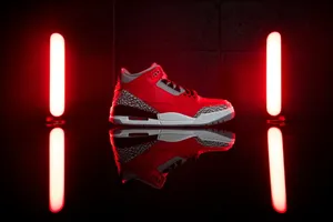 Stylish Pair Of Red Shoes On A Wooden Floor Wallpaper