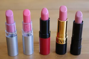 Stylish Pink Lipstick On A Black Background Wallpaper