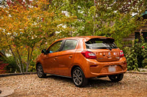 Stylish Red Compact Car Parked On Scenic Road Wallpaper