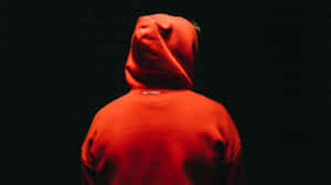 Stylish Red Hoodie On A Hanger Against Wooden Background Wallpaper