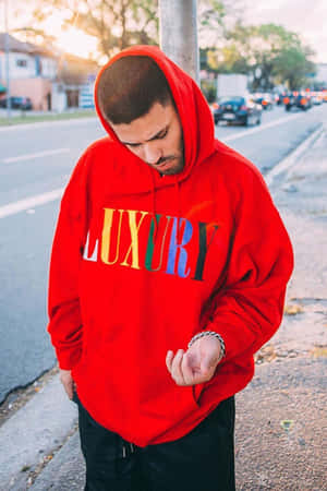 Stylish Red Hoodie On A Wooden Hanger Wallpaper