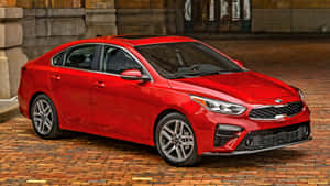 Stylish Red Kia Forte On Road Wallpaper