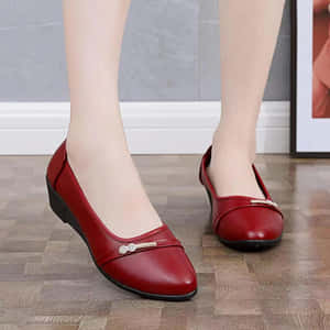 Stylish Red Shoes On A Wooden Floor Wallpaper