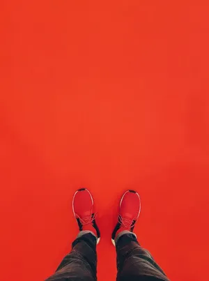 Stylish Red Shoes On A Wooden Floor Wallpaper
