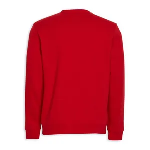 Stylish Red Sweater In A Cozy Setting Wallpaper