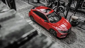 Stylish, Sleek Red Hatchback In Action Wallpaper