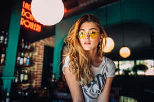 Stylish Sunglasses Reflecting The Mesmerizing Sunset Wallpaper