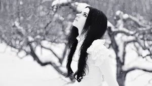 Stylish Woman In Chic Winter Outfit Wallpaper