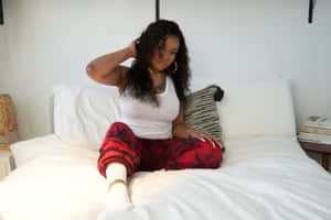 Stylish Woman Sittingon Bed Wallpaper