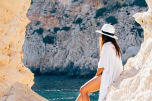 Stylish Woman Walking On The Beach During A Sunny Summer Day Wallpaper