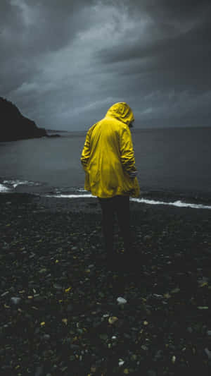 Stylish Yellow Raincoat In Action Wallpaper