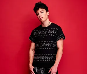 Stylish Young Man Red Backdrop Wallpaper