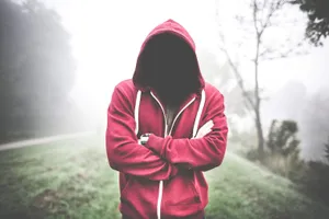 Stylish Young Man Wearing A Red Hoodie Wallpaper