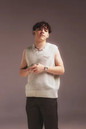 Stylish Young Manin Sweater Vestand Accessories Wallpaper