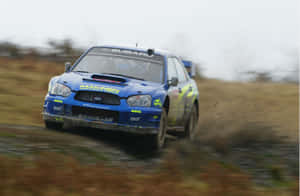 Subaru Rally Car Speeding Through Field Wallpaper