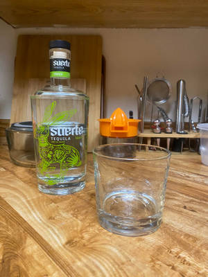 Suerte Tequila Bottle And Rock Glass Wallpaper