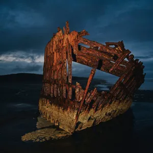 Sunken Secrets: A Stunning View Of An Old Shipwreck Wallpaper