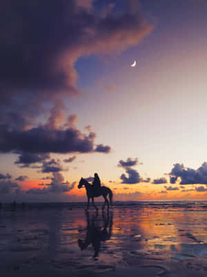 Sunlit Beach And Brightly-colored Sky Wallpaper