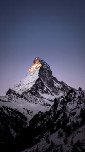 Sunlit_ Mountain_ Peak_at_ Dusk Wallpaper