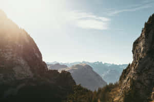 Sunlit_ Mountain_ Valley_ View.jpg Wallpaper