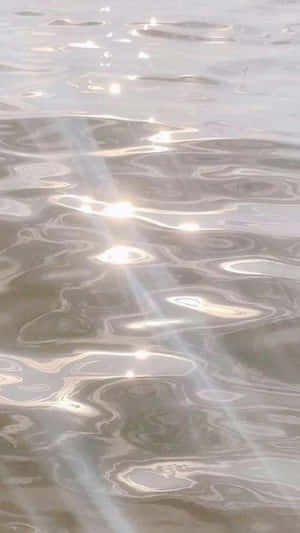 Sunlit_ Water_ Ripples_ Ethereal_ Aesthetic.jpg Wallpaper