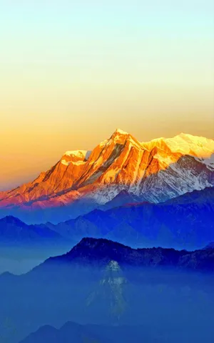 Sunrise_ Glow_on_ Mountain_ Peaks.jpg Wallpaper