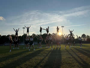 Sunset Cheerleading Practice Silhouette Wallpaper