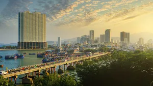 Sunset Cityscape With Bridgeand Boats Wallpaper