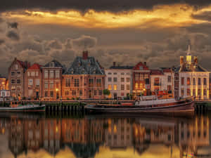 Sunset Glow Over Hengelo Canal Houses Wallpaper