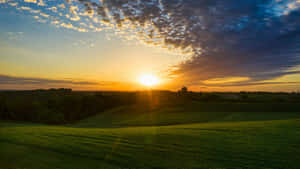 Sunset Over Rolling Farmland Wallpaper