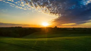 Sunset Over Rolling Farmland Wallpaper
