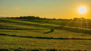 Sunset Over Rolling Farmland Wallpaper