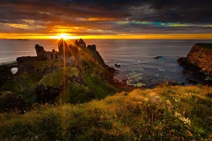 Sunset Through Dunluce Castle In Northern Ireland Wallpaper