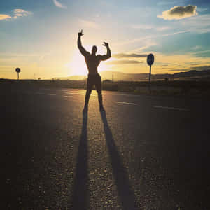 Sunset Victory Pose Silhouette Wallpaper