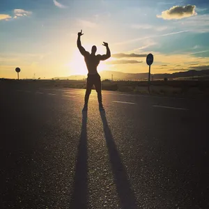 Sunset Victory Pose Silhouette Wallpaper