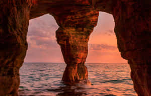 Sunset View Through Sea Cave Wallpaper