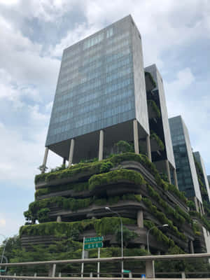 Sustainable Green Building Facade In Urban Setting Wallpaper