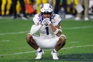 T C U Football Player Contemplative Moment Wallpaper