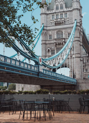 Tables And Chairs Under Tower Bridge Wallpaper