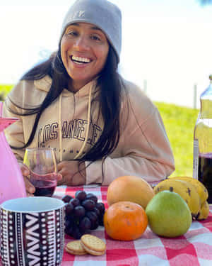 Taila Santos Smiling At Picnic Table Wallpaper