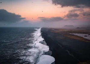 Take A Breath Of Fresh Air And Experience The Beauty Of Nature In This Black Sand Beach. Wallpaper