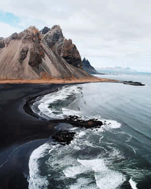 Take A Moment To Appreciate The Beauty Of A Black Sand Beach. Wallpaper
