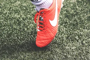 Take Control Of The Game With Nike Football Shoes Wallpaper