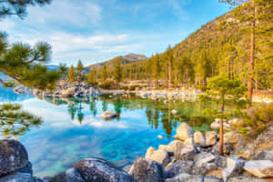 Take In The Breathtaking Views Of Lake Tahoe With Its Picturesque Snow-capped Mountains And Crystal Blue Waters. Wallpaper