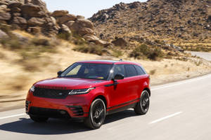 Take On Any Adventure With The Red Land Rover Suv Wallpaper