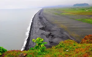 Take Time To Relax At This Beautiful Black Sand Beach Wallpaper