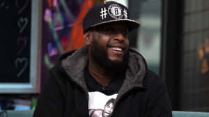 Talib Kweli Smiling During Interview Wallpaper