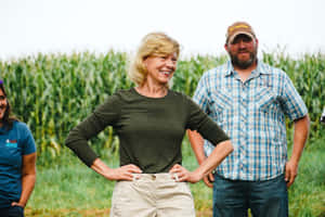 Tammy Baldwin Standing In A Cornfield Wallpaper