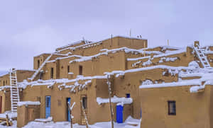 Taos Pueblo Covered In Snow Wallpaper